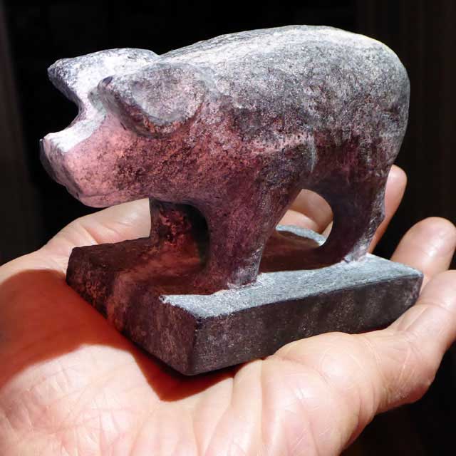 Stone carving of piglet